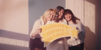 three women with a sign that say abortion is ok